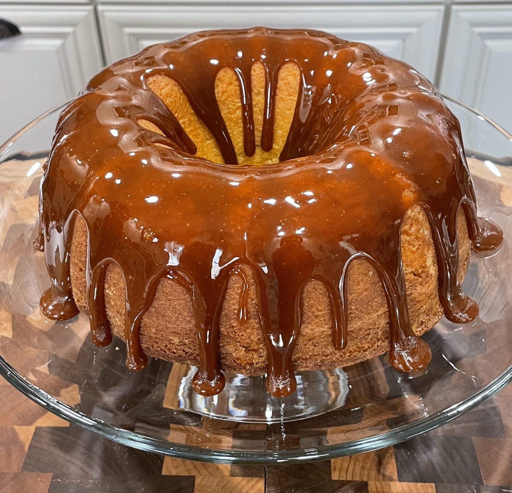 Caramel bundt cake on a glass stand
