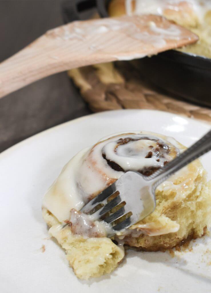 Cinnamon roll on a plate with fork