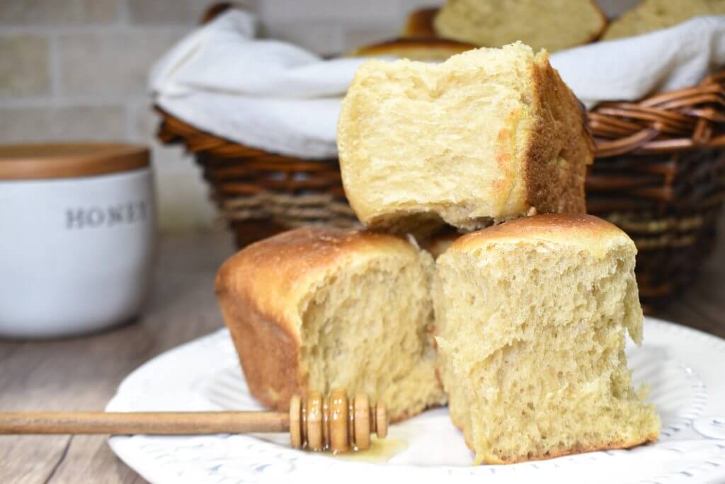 Sourdough Milk Brioche Rolls on a plate with honey jar