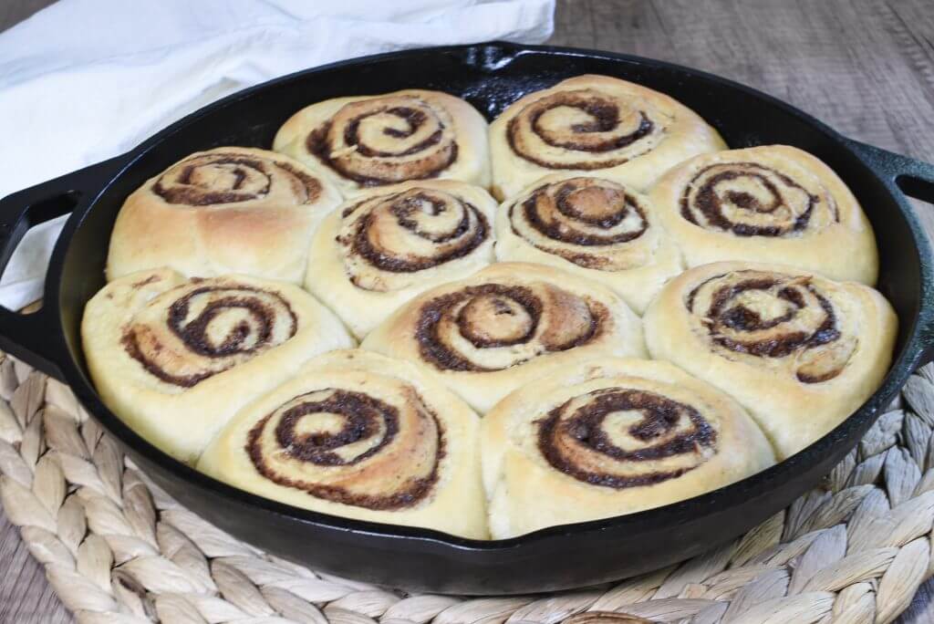 Unglazed sourdough cinnamon rolls in a cast iron skillet