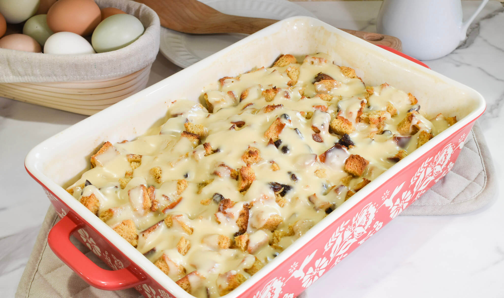 Sourdough bread pudding in baking dish with eggs
