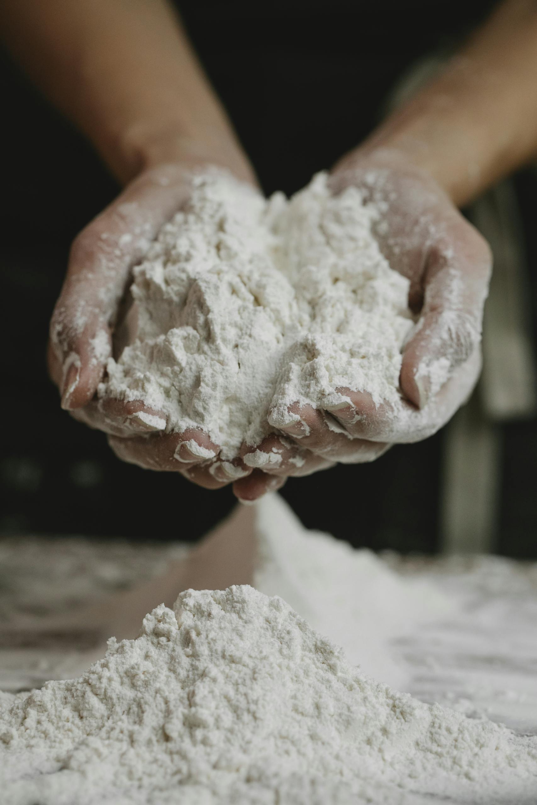 10 Best Organic Flour Brands For Home Baking In 2025 A Baker S Guide Close Up Of A Person Holding A Mound Of Flour In Their Hands Inside A Kitchen. 6287581 Scaled